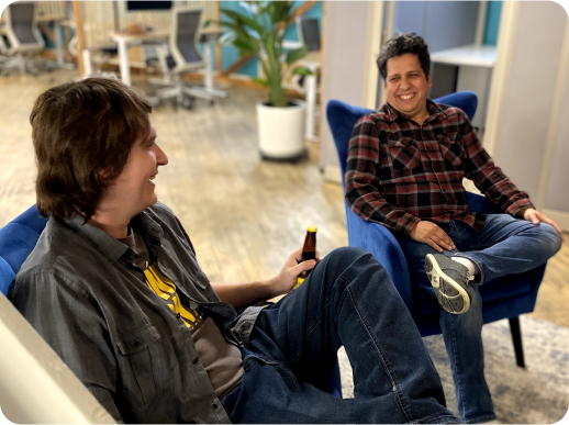 Two coworking members sitting in the lounge area sharing a drink